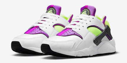 White Nike Air Huarache with neon green and purple accents, black sole, lifestyle sneaker